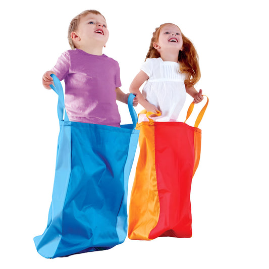 Two children playing with colorful bean bags on a white background